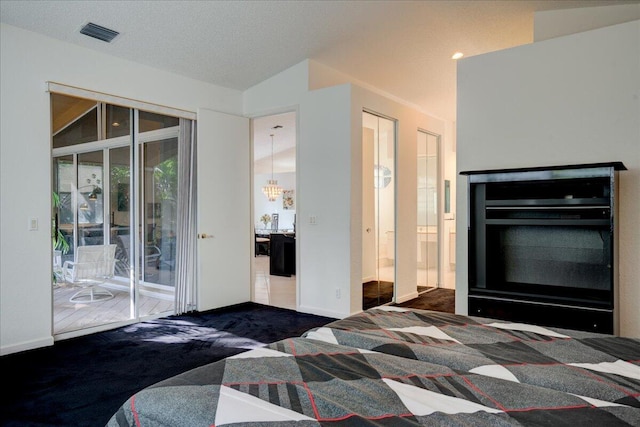 carpeted bedroom featuring a textured ceiling, access to outside, lofted ceiling, and a notable chandelier