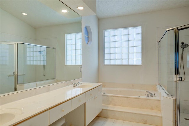 bathroom with tile patterned flooring, vanity, a textured ceiling, and independent shower and bath