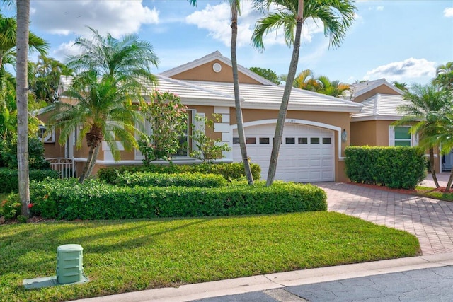 view of front of house with a front yard and a garage