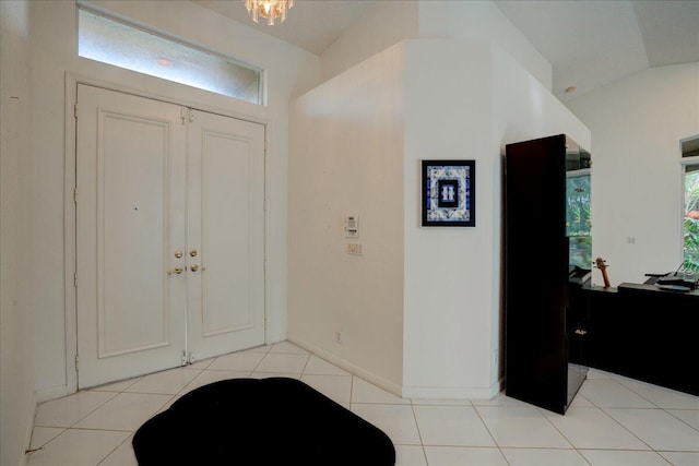 entryway with light tile patterned floors and a healthy amount of sunlight