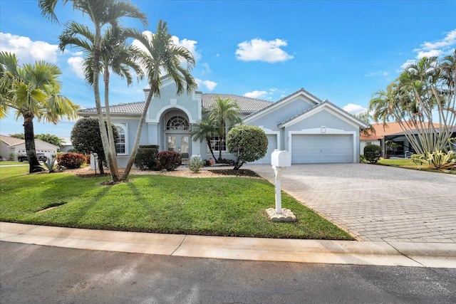 view of front facade with a garage and a front yard