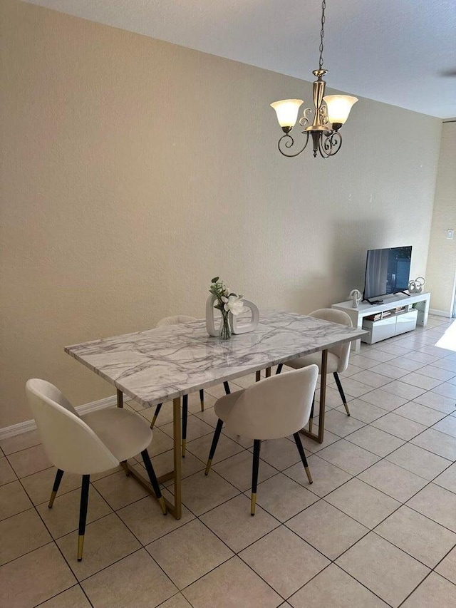 tiled dining room with a notable chandelier