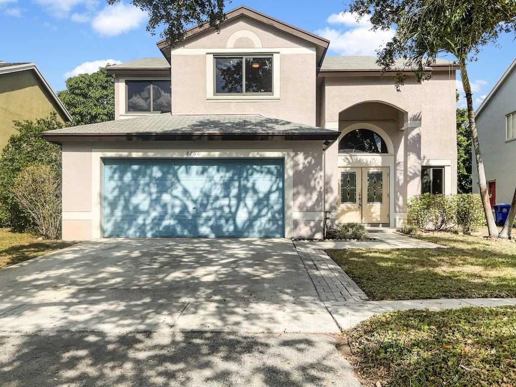 view of front of home featuring a garage and french doors