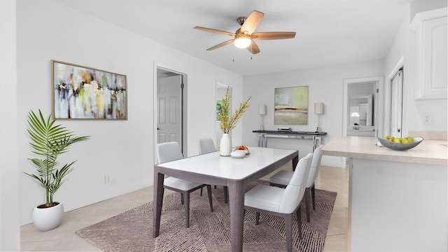 tiled dining area with ceiling fan