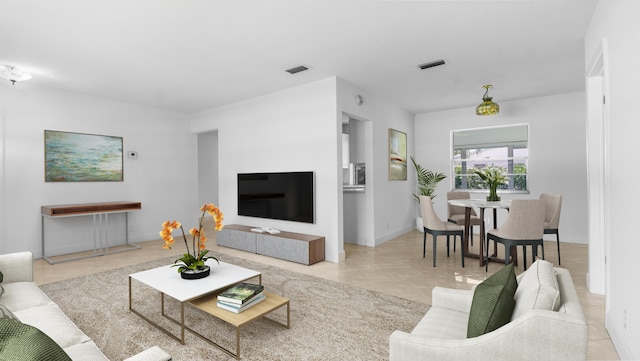 living area with tile patterned flooring and visible vents