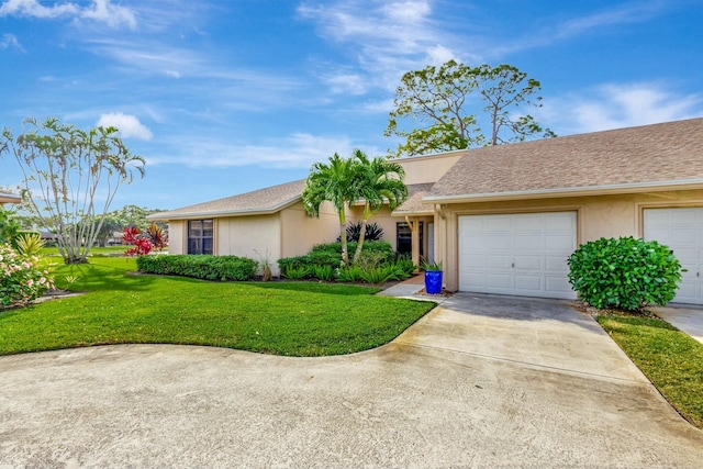 single story home featuring a garage and a front lawn