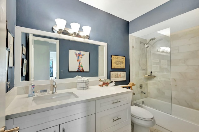 full bathroom with toilet, vanity, and tiled shower / bath