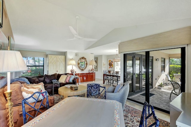 tiled dining room featuring ceiling fan, a healthy amount of sunlight, and lofted ceiling