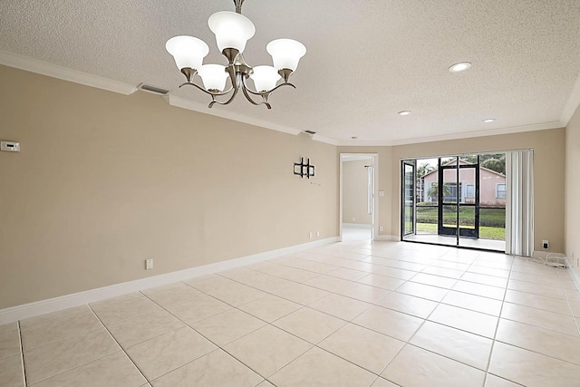 tiled empty room with a textured ceiling, ornamental molding, and a chandelier