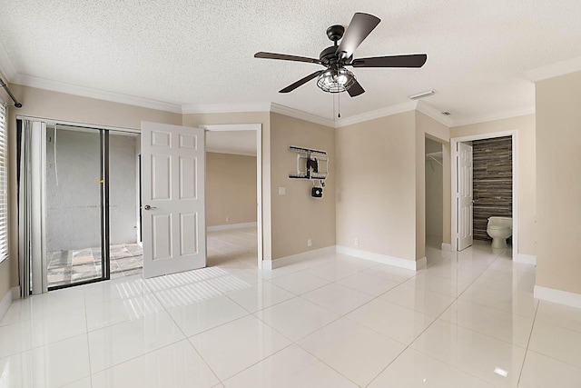 unfurnished bedroom with ensuite bathroom, ornamental molding, light tile patterned floors, ceiling fan, and a closet