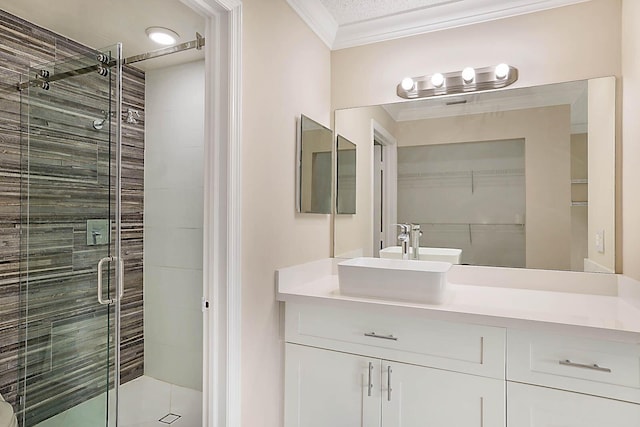 bathroom featuring ornamental molding, vanity, and an enclosed shower