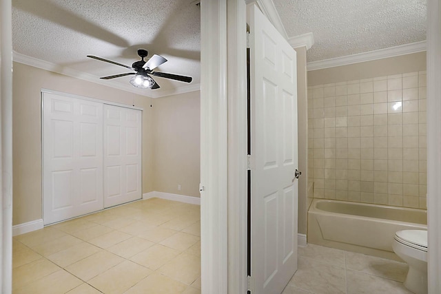 bathroom featuring crown molding, tile patterned floors, and a textured ceiling