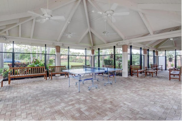 sunroom / solarium featuring ceiling fan and lofted ceiling with beams