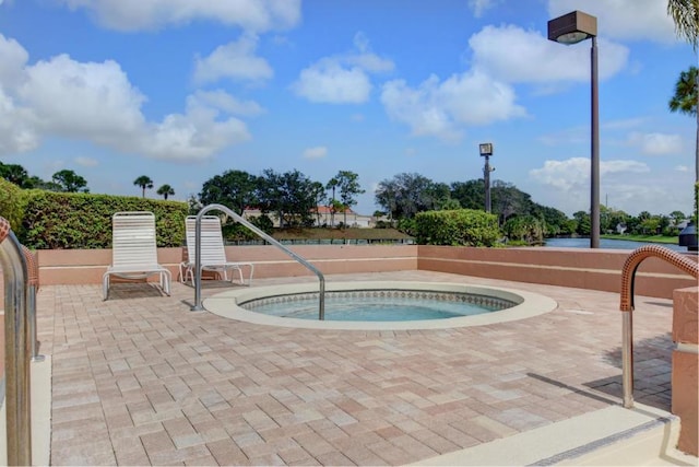 view of pool with an in ground hot tub and a patio