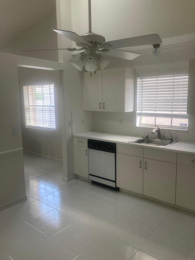 kitchen featuring dishwasher, sink, vaulted ceiling, and light tile patterned flooring