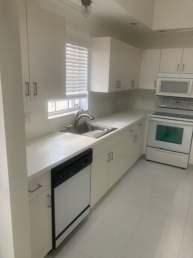 kitchen featuring white cabinets, white appliances, and sink