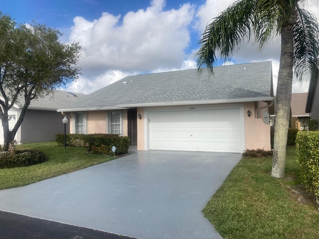 single story home featuring a garage and a front lawn