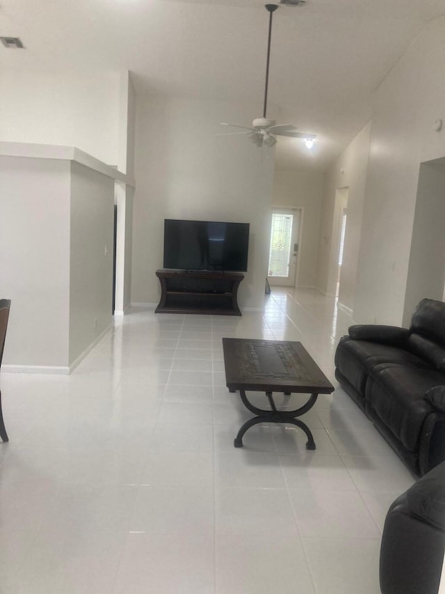 tiled living room with ceiling fan