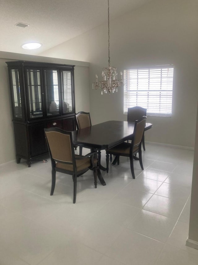 dining room with light tile patterned floors and an inviting chandelier