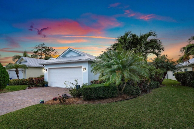 view of front of property with a yard and a garage