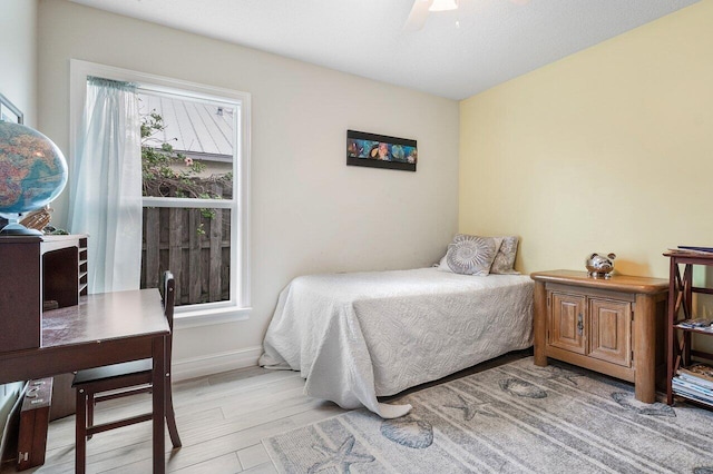 bedroom with light wood-type flooring and ceiling fan