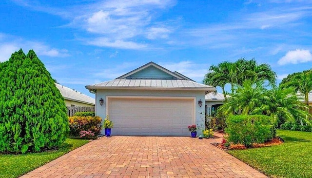 view of front of home with a front yard and a garage