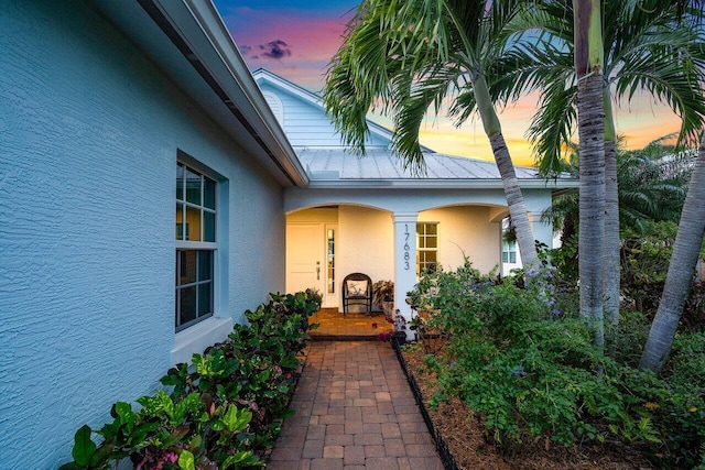 view of exterior entry at dusk