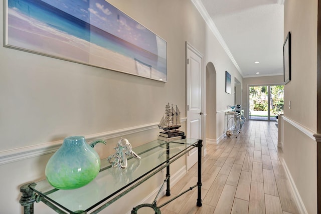 hall featuring crown molding and light hardwood / wood-style flooring