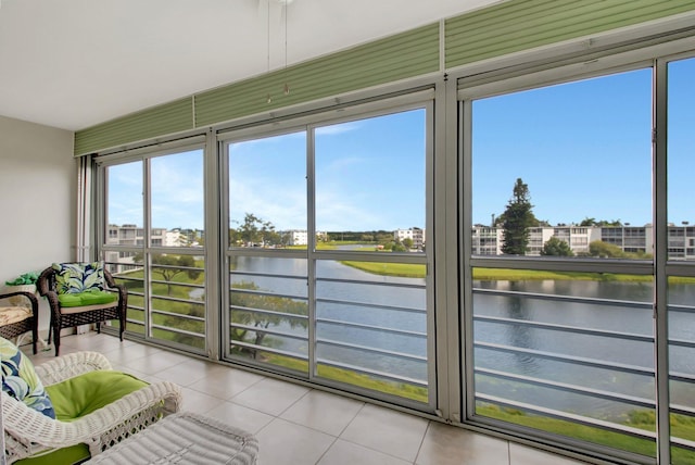 sunroom / solarium featuring a water view