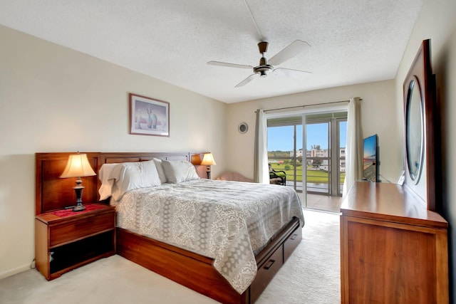 carpeted bedroom with ceiling fan, a textured ceiling, and access to outside