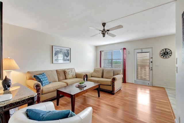 living room with light wood-type flooring and ceiling fan