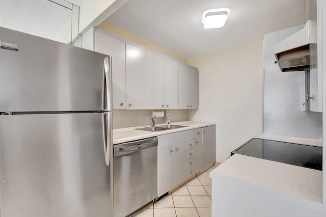 kitchen featuring sink, white cabinetry, stainless steel appliances, and light tile patterned flooring