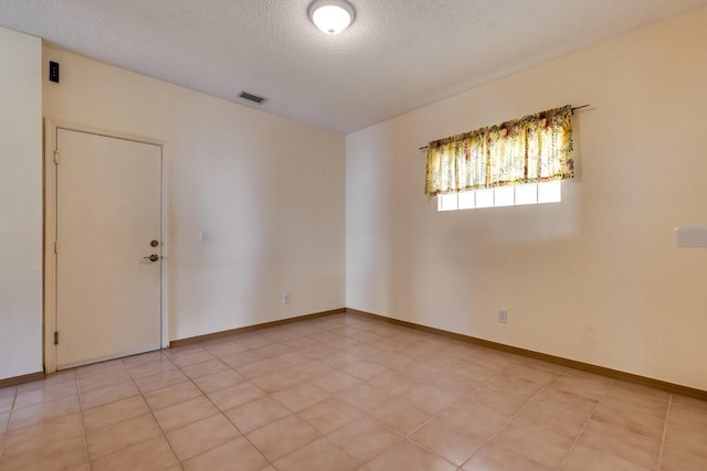 unfurnished room featuring a textured ceiling