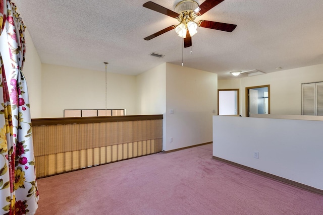 empty room with carpet flooring and a textured ceiling