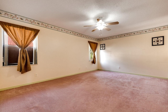 carpeted spare room with ceiling fan and a textured ceiling