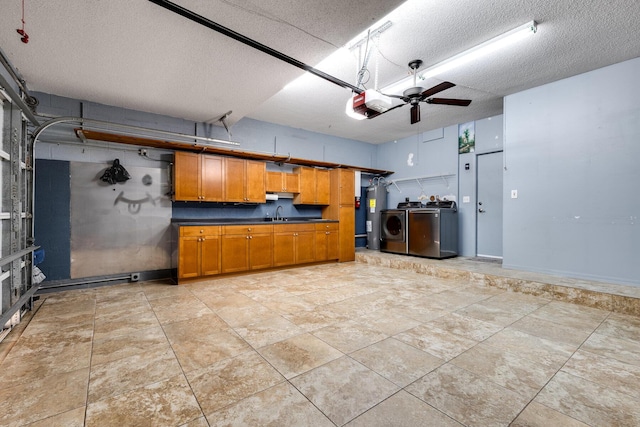 kitchen with water heater, sink, and a textured ceiling