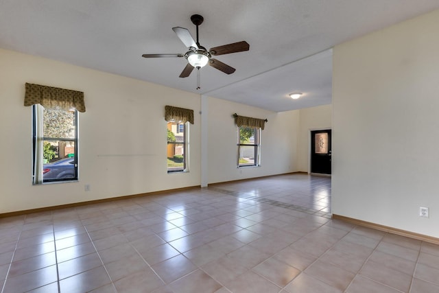 tiled empty room featuring ceiling fan