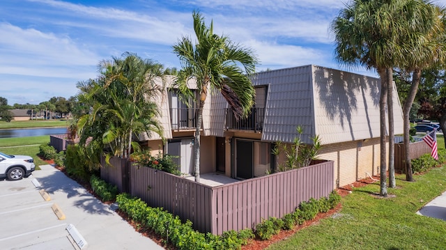 view of side of home with a water view