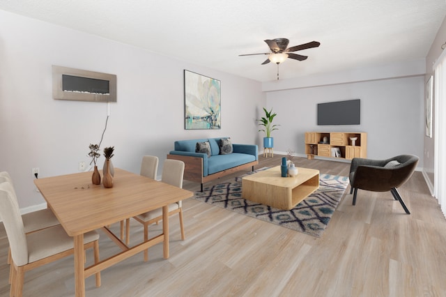 living room featuring light wood-type flooring and ceiling fan