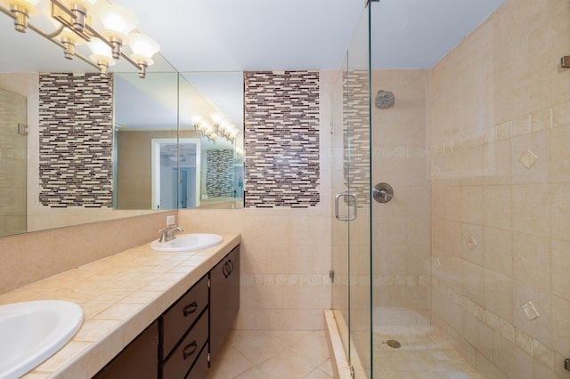 bathroom with vanity, an inviting chandelier, tile patterned floors, and an enclosed shower