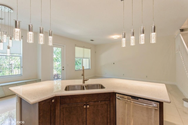 kitchen with dishwasher, a sink, plenty of natural light, and dark brown cabinets