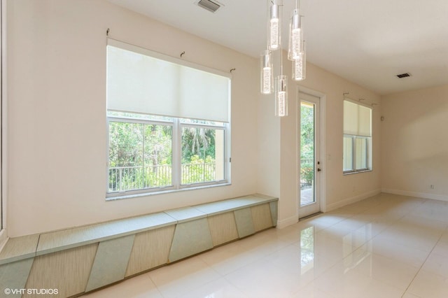 unfurnished dining area featuring light tile patterned floors and baseboards