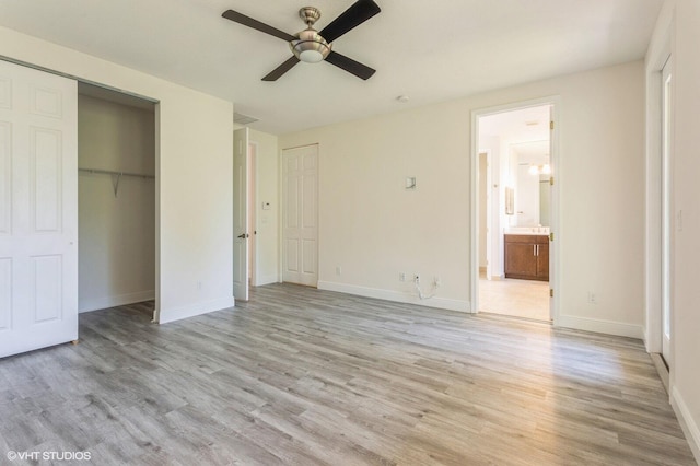 unfurnished bedroom with light wood-style flooring and baseboards