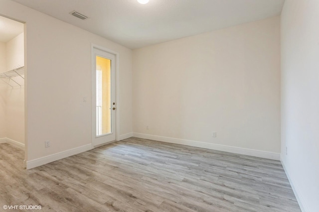 empty room with light wood-style floors and baseboards
