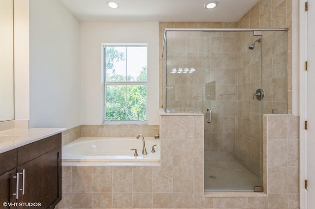 bathroom featuring a shower stall, vanity, a bath, and recessed lighting