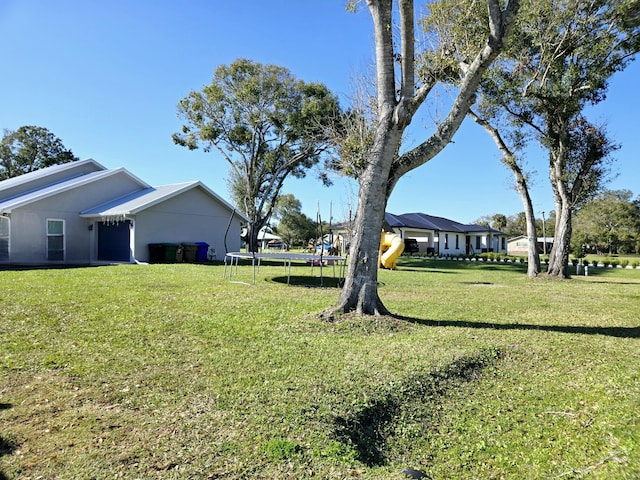 view of yard with a trampoline