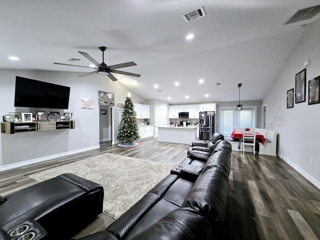 living room with ceiling fan, hardwood / wood-style floors, and lofted ceiling