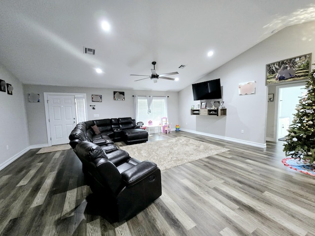 living room featuring ceiling fan, wood-type flooring, and vaulted ceiling