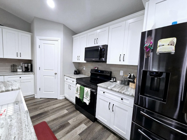 kitchen featuring stainless steel fridge with ice dispenser, electric range, tasteful backsplash, and white cabinetry