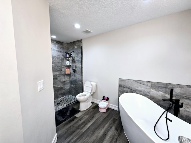 bathroom with separate shower and tub, hardwood / wood-style floors, a textured ceiling, and toilet